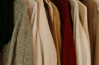 brown-and-white-coat-hanged-on-rack.jpg brown and white coat hanged on rack